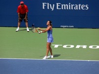 Amelie Mauresmo serving.