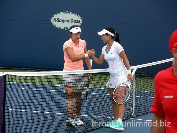 Alberta Brianti and Jie Zheng shake hands at Rogers Cup 2011.