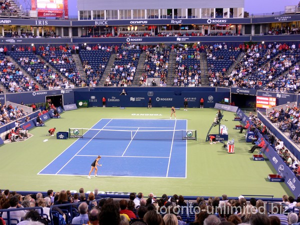 Jovanovski and Sharapova playing at sunset.