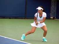 Jie Zheng of China returning a ball. Rogers Cup 2011.