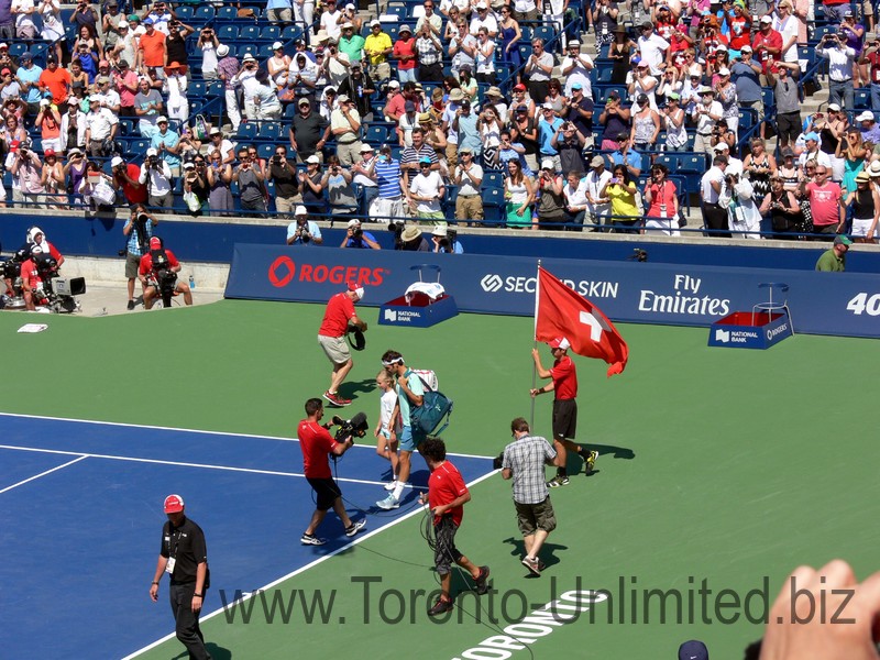 Roger Federer and Swiss flag coming to the Stadium Court to play the Championship final; August 10, 2014 Rogers Cup Toronto  