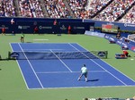 Roger Federer and Jo-Wilfried Tsonga in the second set on the Stadium Court August 10, 2014 Rogers Cup 