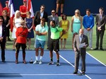 Rogers Cup Stadium Court Master of Ceremonies Ken Crosina giving speech, while Roger Federer and Jo-Wilfried Tsonga look on August 10, 2014 Rogers Cup Toronto 