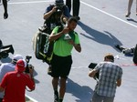 Jo-Wilfried Tsonga with his trophy is leaving the Stadium Court at Rexall Centre, August 10, 2014 Rogers Cup Toronto