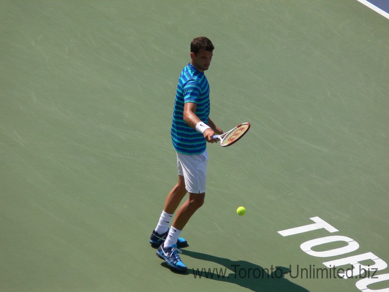 Grigor Dimitrov picking up the ball to serve on Stadium Court August 9, 2014 Rogers Cup Toronto