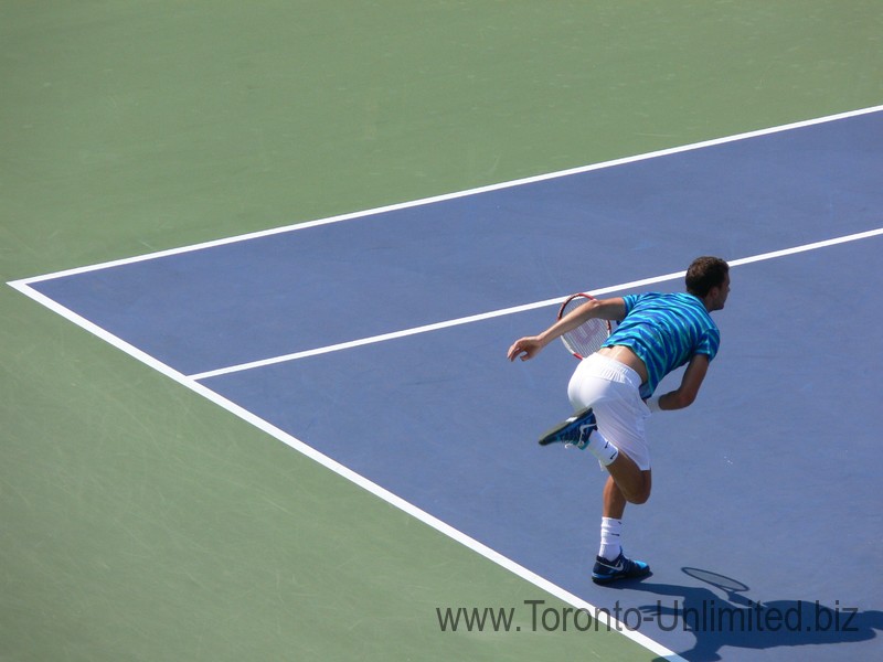 Grigor Dimitrov finishes his serve. Stadium Court August 9, 2014 Rogers Cup Toronto