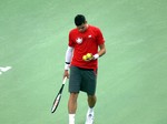 Milos Raonic Canada selecting ball to serve on Stadium Court August 6, 2014 Rogers Cup Toronto