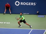 Jo-Wilfried Tsonga running on baseline, playing Novak Djokovic on Stadium Court August 7, 2014 Rogers Cup Toronto