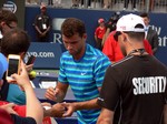 Grigor Dimitrov (BUL) signing autographs on Grandstand Court August 7, 2014 Rogers Cup Toronto