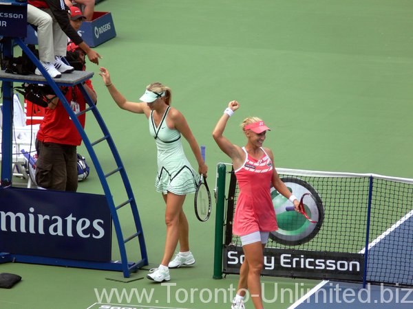 Jubilant Dementieva and Sharapova behind.