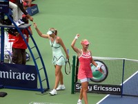 Jubilant Dementieva and Sharapova behind.