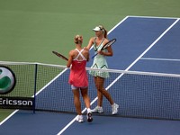 Dementieva and Sharapova shaking hands at the net.