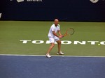 Andre Agassi with full concentration preparing to seturn serve