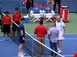 Jim Courier and Andre Agassi, coin toss before exhibition game.