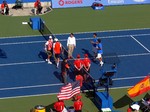 Bob Bryan with Mike Bryan in the left are standing on the court for coin tossup with Marcell Granollers and Marc Lopez, August 12, 2012 Rogers Cup doubles final.