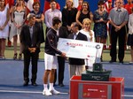 Novak Djokovic is receiving winner's cheque for US$ 522,555 and the Trophy. August 19, 2012 Rogers Cup.