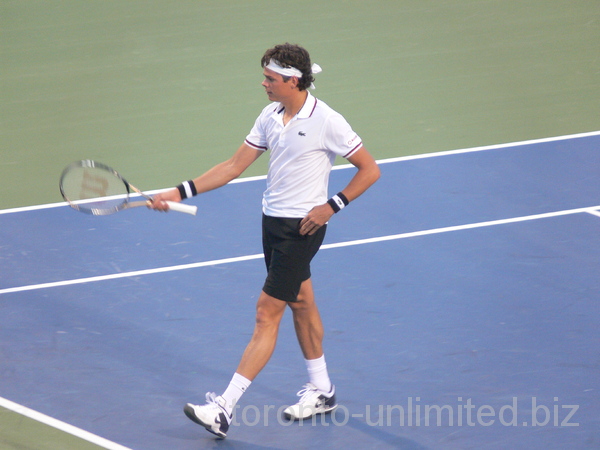 Milos Raonic is about to serve to Victor Troicki.