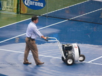 Tonny Cho, referee, is helping to dry up Central Court. August 11, 2012 Rogers Cup.  