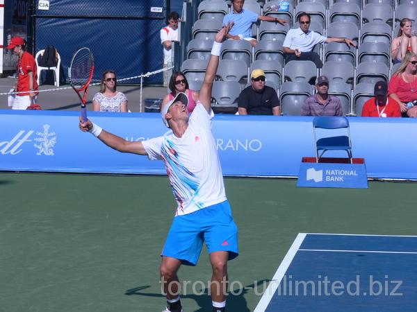 Vasek Pospisil of Canada has a nice serve to Juan Monaco of Argentina, Grandstand Court August 7, 2012 Rogers Cup.