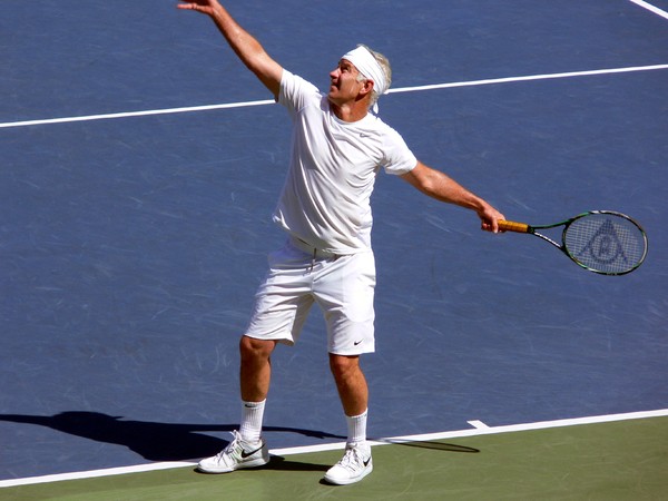 Beatiful serving motion of John McEnroe playing Jim Courier in an exhibition game August 11, 2013 Rogers Cup Toronto