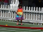 Little girl with a big tennis racquet. Kids tennis attract very young at Rogers Cup 2013 Toronto.