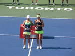 Champion Belinda Bencic and runner-up Simona Halep on Centre Court with a prominent sign promoting Toronto, 16 August 2015 Rogers Cup.