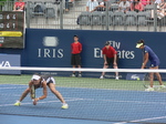 Martina Hingis crouching behind the net while Sanja Mirza is serving on Grandstand Court 14 August 2015 Rogers Cup Toronto
