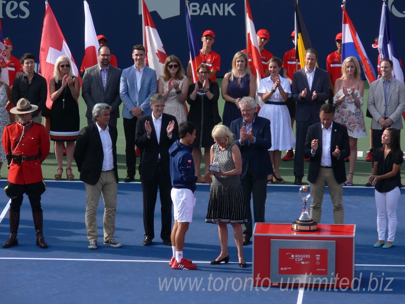 Karen Leggett of National Bank is presenting runnerup's trophy to Kei Nishikori 31 August 2016 Rogers Cup Toronto