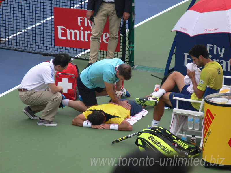 Ivan Dogic is receiving on the court treatment from the trainer