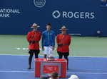 Novak Djokovic with Championship Trophy and RCMP Honor Guard on Centre Court of Aviva Centre