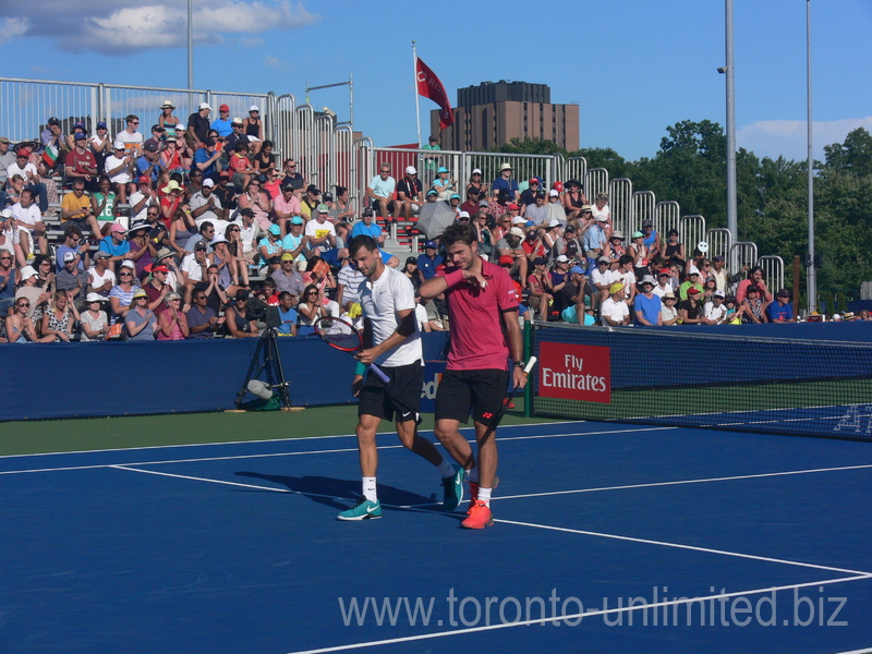 Stan Warinka with Grigor Diitrov at service line during doubles match against Lucas Poille and Dominic Thiem 25 July 2016 Rogers Cup Toronto