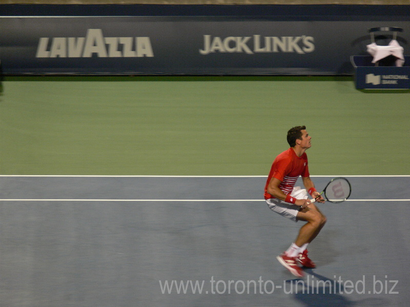 Milos Raonic is at the Net volleying Gael Monfils on Central Court 29 July 2016 Rogers Cup Toronto