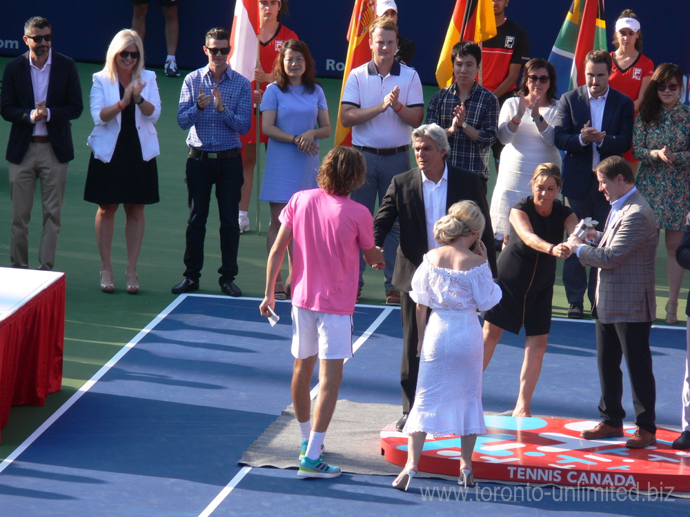 Stefanos Tsitsipas about to receive Runners Up Trophy from Louis Vachon.