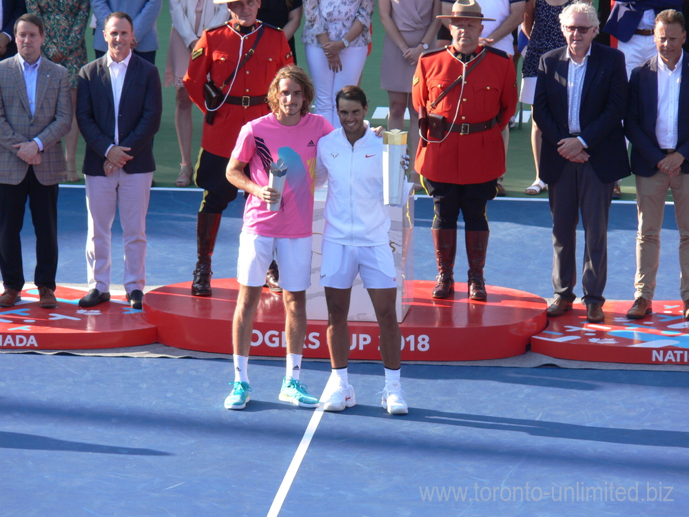 Champion Rafael Nadal and Runner up Stefanos Tsitsipas holding each other and their Trophies