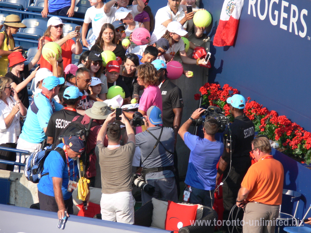 Stefanos Tsitsipas signing autographs to the fans August 11, 2018