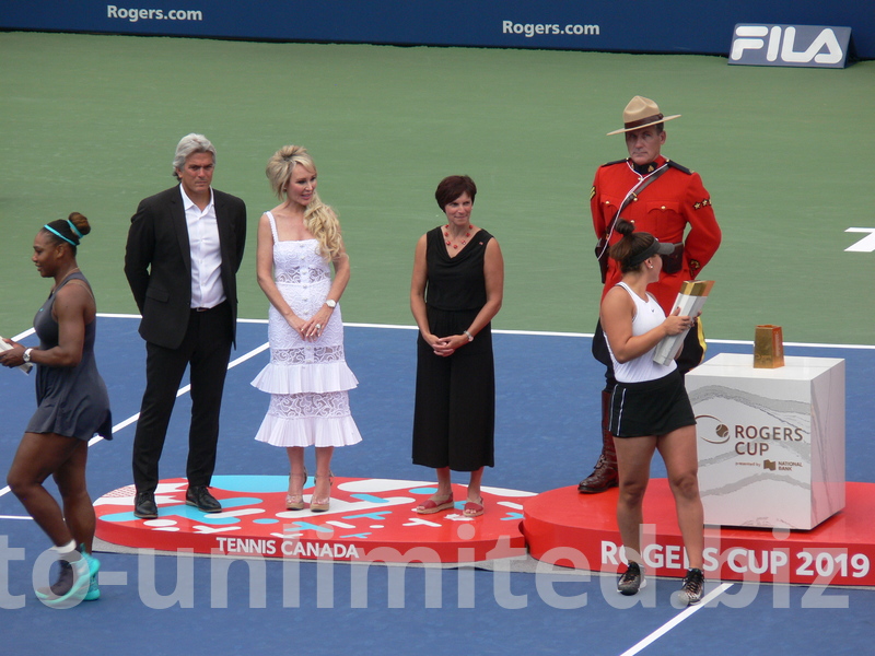 Serena Williams with her Trophy and Binaca Andrescu with her are leaving to meet with members of their support teams, August 11, 2019