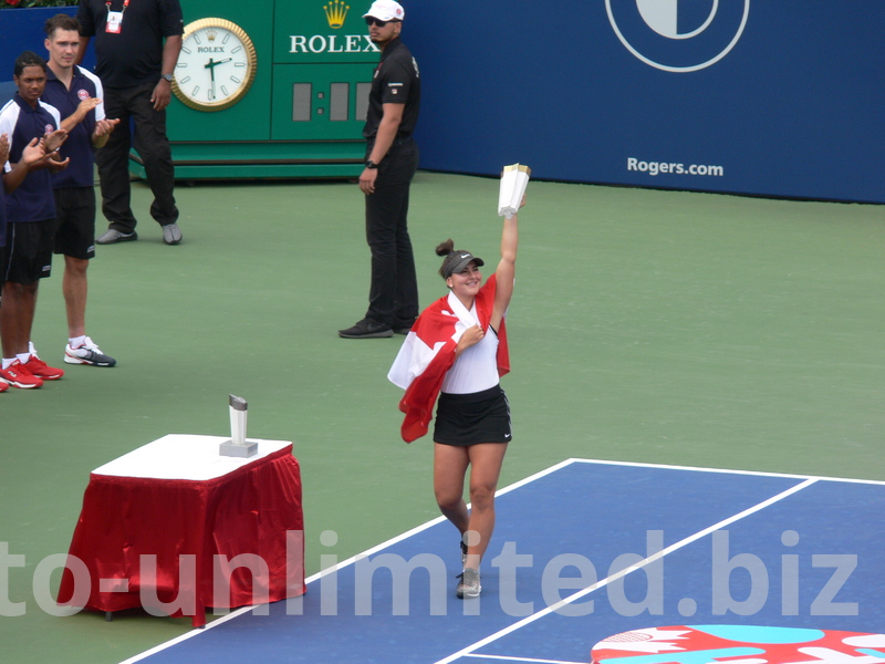 Happy Champion wrapped in Canadian flag and displaying Championship Trophy, August 11, 2019 Rogers Cup Toronto