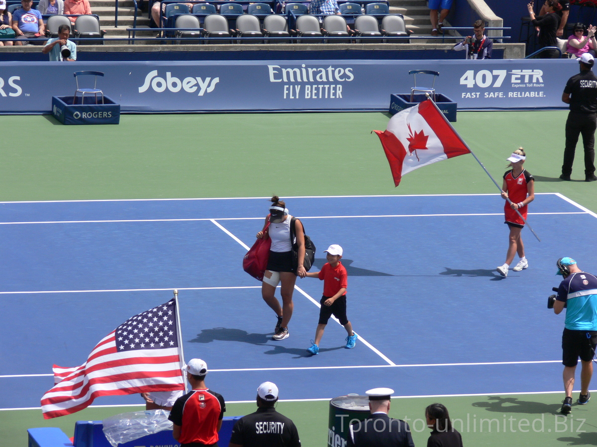 Bianca Andrescu with her headset and Canadian flag behind her coming to Centre Court to play semifinal match, August 9, 2019 Rogers Cup in Toronto