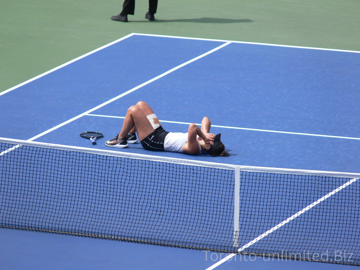 Happy Bianca Andrescu lies-down on the court to celebrate her win and entry into Rogers Cup Final next day.