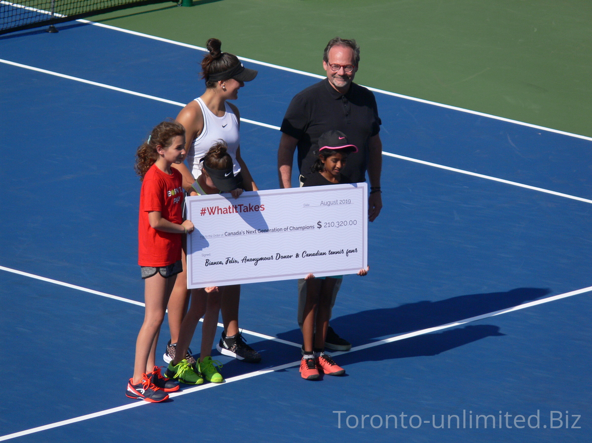 On the Court Presentation with Michael Downey, President and CEO of Tennis Canada, Bianca Andrescu holding cheque  of $210,320.00 as donation for Canada Next Generation of Champions, August 8, 2019.