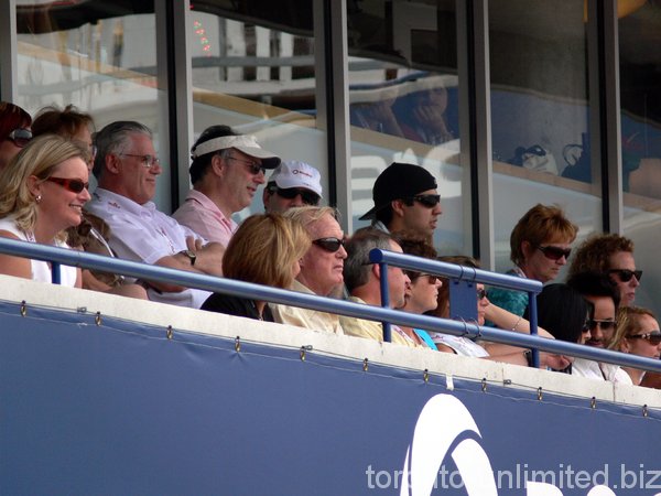 Ted Rogers (with glasses) sitting in Tennis Canada Lounge.