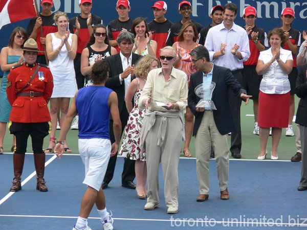 Ted Rogers giving a winner cheque to Rafael Nadal.